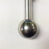 A metal ball and rod hanging on the wall.